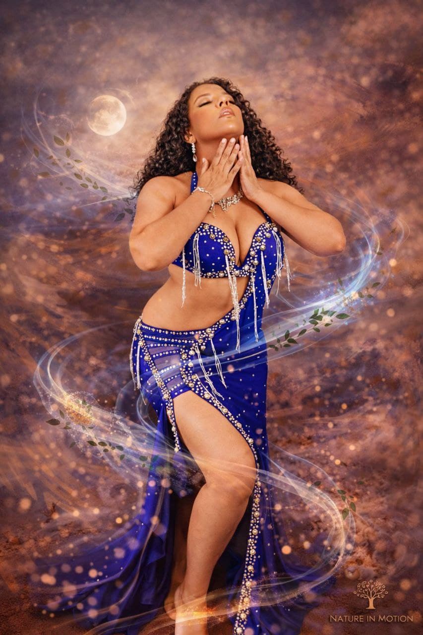 Marcelly dancing in a blue belly dance costume